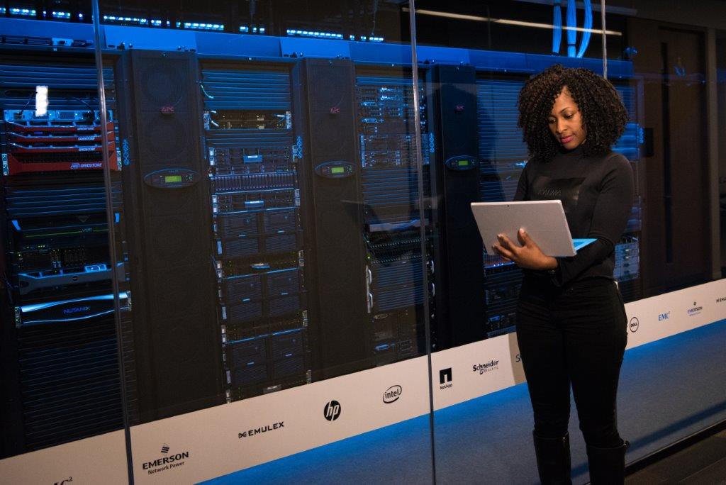 person in front of server rack